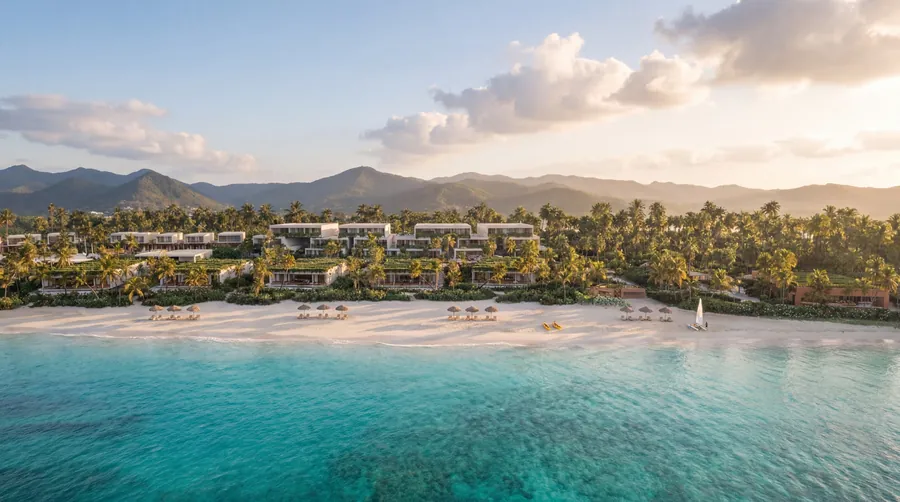 Four Seasons Resort Dominican Republic at Tropicalia: white beach, turquoise water and low pavilions among palms on Samaná Bay